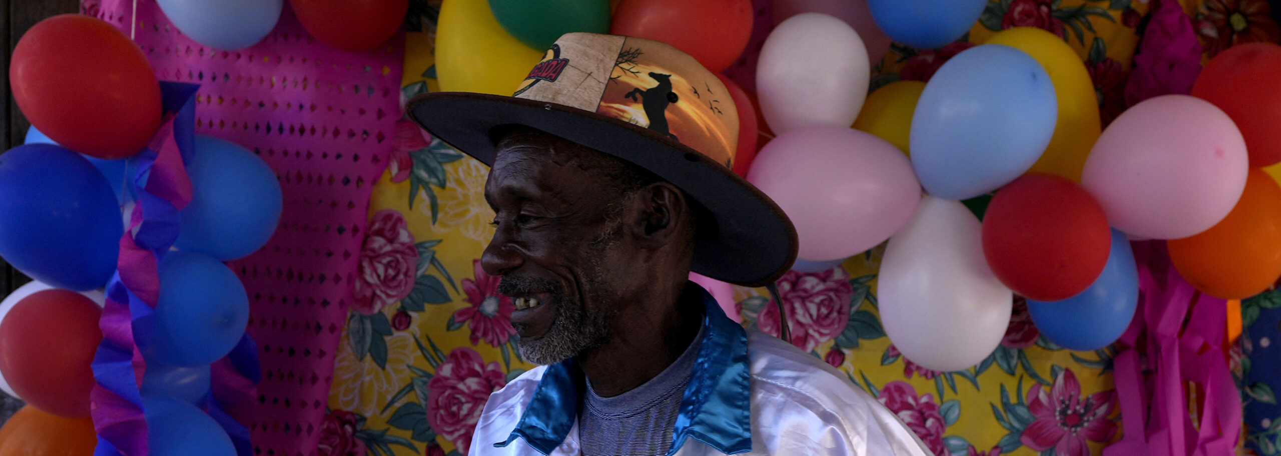 A man dressed as a servant in the Emperor's procession in the Kalunga quilombo, the descendants of runaway slaves, during the culmination of the week-long pilgrimage and celebration for the patron saint "Nossa Senhora da Abadia" or Our Lady of Abadia, in the rural area of Cavalcante in Goias state, Brazil, Monday, Aug. 15, 2022. Devotees celebrate Our Lady of Abadia at this time of the year with weddings, baptisms and by crowning distinguished community members, as they maintain cultural practices originating from Africa that mix with Catholic traditions. (AP Photo/Eraldo Peres) (AP Photo/Eraldo Peres)